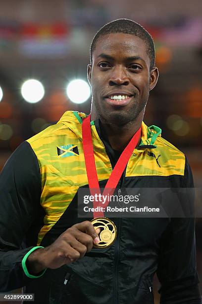 Gold medallist Andrew Riley of Jamaica poses on the podium during the medal ceremony for the Mens 110 metre hurdles at Hampden Park during day six...