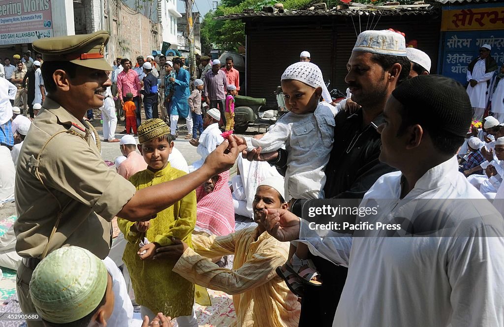 A policeman offers roses to a Muslim during prayer offerings...