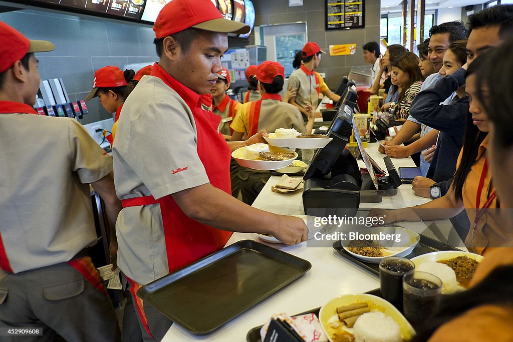 Jollibee CEO Ernesto Tanmantiong And Customers Inside A Jollibee Restaurant