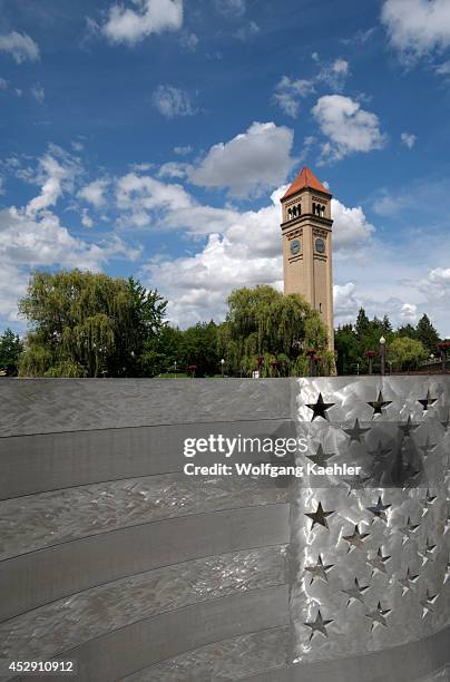 Washington State, Spokane, Riverfront Park, Aluminum Bench Art, Clock Tower In Background.