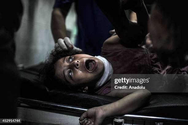 An injured Palestinian kid receives treatment at Kamal Adwan hospital in Beit Lahia, Gaza on July 30, 2014. The death toll from the Israeli shelling...