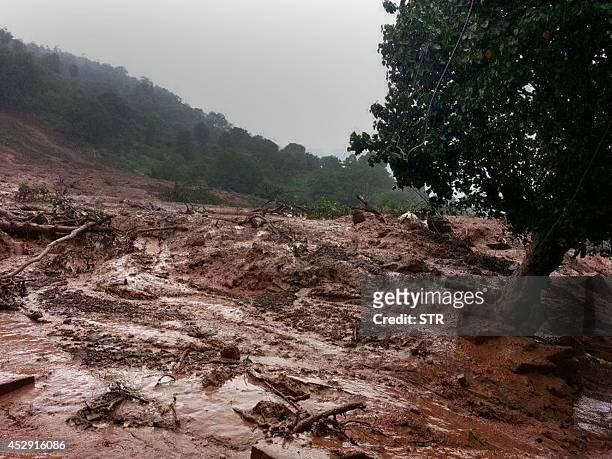 Mudslide is seen in Malin village in Pune district the western Indian state of Maharashtra on July 30, 2014. A major landslide struck a village in...