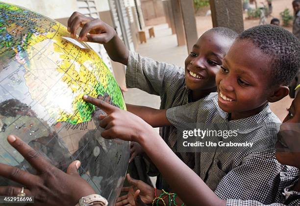 African schoolchildren playing with a globe on April 25 in Ouagadougou, Burkina Faso.