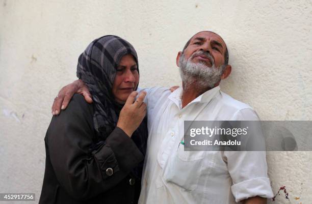 Palestinians mourn after an Israeli strike on a UN-run school, in Beit Lahia, Gaza on July 30, 2014. The death toll from the Israeli shelling of a...
