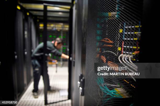 An employee of Equinix data center checks servers on July 21, 2014 in Pantin, a suburb north of Paris in the Seine-Saint-Denis department. Data...