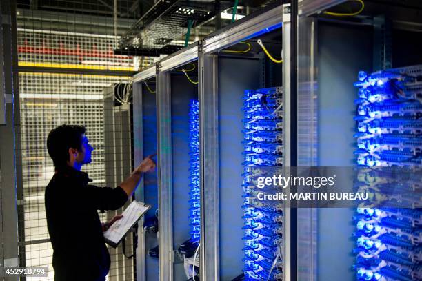 An employee of Equinix data center checks servers on July 21, 2014 in Pantin, a suburb north of Paris in the Seine-Saint-Denis department. Data...