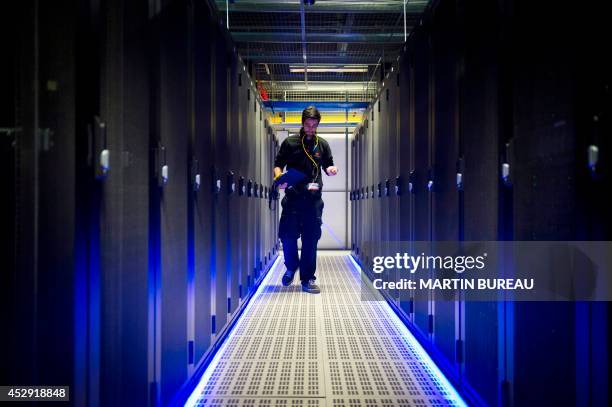 An employee of Equinix data center checks servers on July 21, 2014 in Pantin, a suburb north of Paris in the Seine-Saint-Denis department. Data...