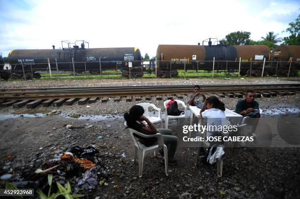 Immigrants rest next to the railtracks in Tierra Blanca, Veracruz, Mexico, on August 21, 2010 waiting for a chance to board a train heading north....