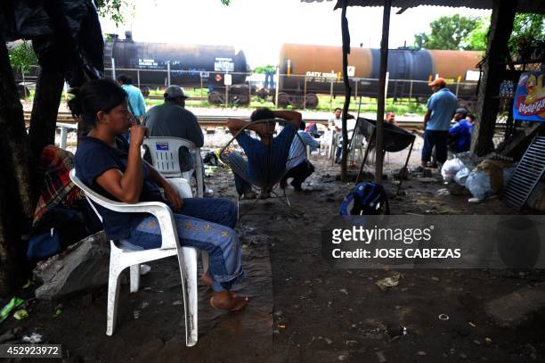 Immigrants rest in a store beside the railtracks in Tierra Blanca, Veracruz, Mexico, on August 21, 2010 waiting for a chance to board a train heading...
