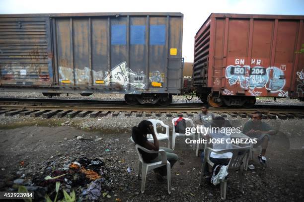 Immigrants rest next to the railtracks in Tierra Blanca, Veracruz, Mexico, on August 21, 2010 waiting for a chance to board a train heading north....