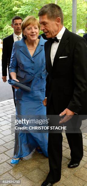 German Chancellor Angela Merkel , her husband Joachim Sauer and his son Daniel Sauer arrive for the show "Siegfried" of the Bayreuth Wagner Opera...