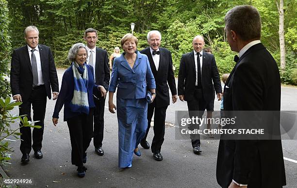 German Chancellor Angela Merkel , her husband Joachim Sauer , his son Daniel Sauer , former mayor of Hamburg, Klaus von Dohnanyi and Nike Wagner ,...