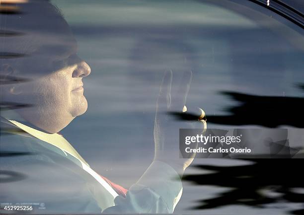 Mayor Rob Ford flashes a peace sign while sitting in his car in the parking lot of the church. A mayors debate was held at Presteign Woodbine United...