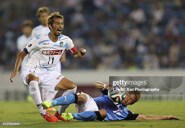 Yasumasa Nishino of Kamatamare Sanuki is tackled by Masahiko Inoha of Jubilo Iwata during the J. League second division match between Jubilo Iwata...