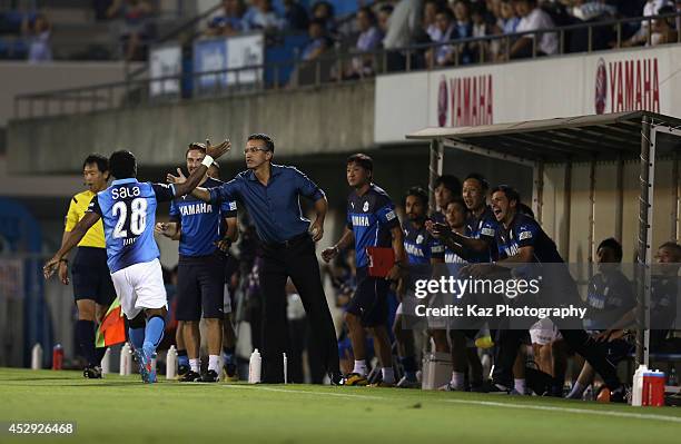 Tinga, whose real name is Paulo Cesar Fonseca do Nascimento celebrates scoring his team's first goal with head coach Pericles Chamusca during the J....