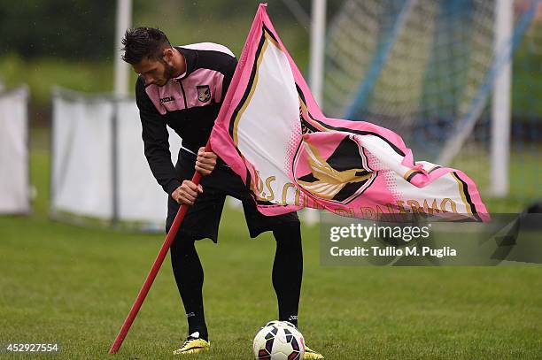 Milan Milanovic holds the flag of US Citta di Palermo during a Palermo training session on July 30, 2014 in Storo near Trento, Italy.