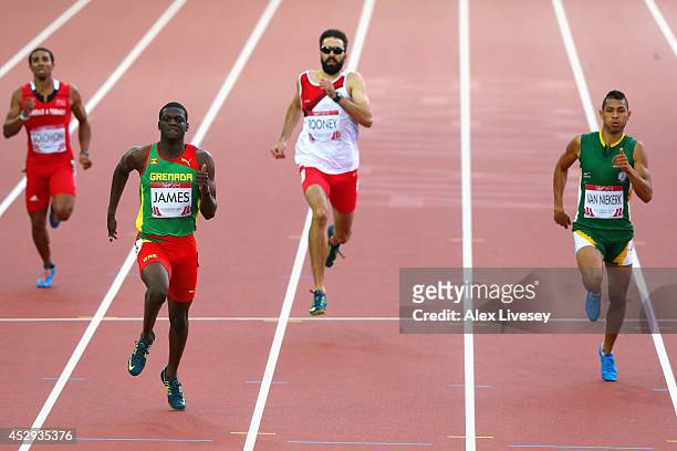 Kirani James of Grenada crosses the line to win gold ahead of Martyn Rooney of England and Wayde van Niekerk of South Africa in the Men's 400 metres...