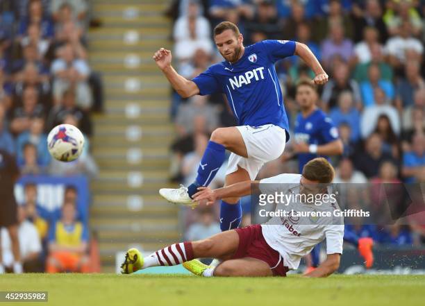 Jimmy Ryan of Chesterfield jumps the challenge of Gary Gardner of Aston Villa during the Pre Season Friendly between Cheterfield and Aston Villa at...