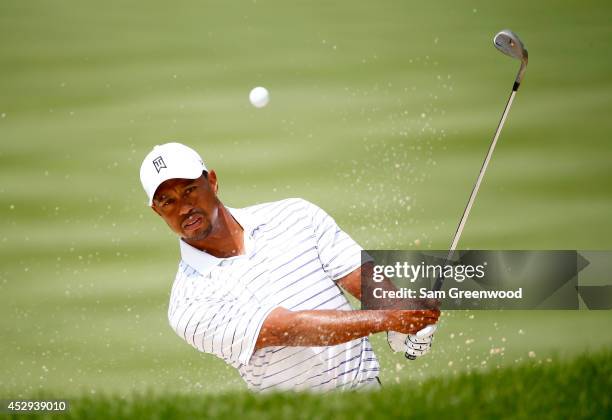 Tiger Woods plays a shot during a practice round for the World Golf Championships-Bridgestone Invitational at Firestone Country Club South Course on...