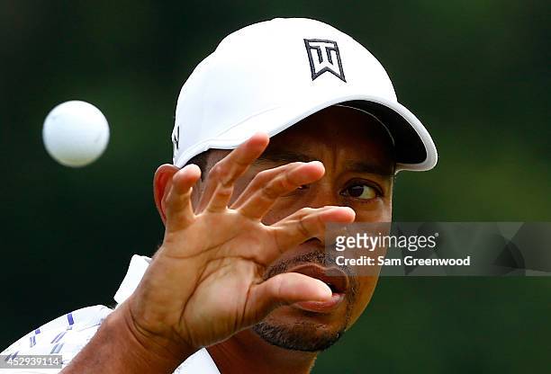 Tiger Woods catches a ball during a practice round for the World Golf Championships-Bridgestone Invitational at Firestone Country Club South Course...