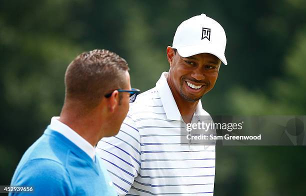 Tiger Woods and his coach Sean Foley walk down the second hole during a practice round for the World Golf Championships-Bridgestone Invitational at...