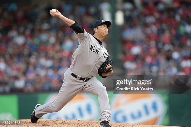 Hiroki Kuroda of the New York Yankees throws in the first inning against the Texas Rangers at Globe Life Park in Arlington on July 30, 2014 in...