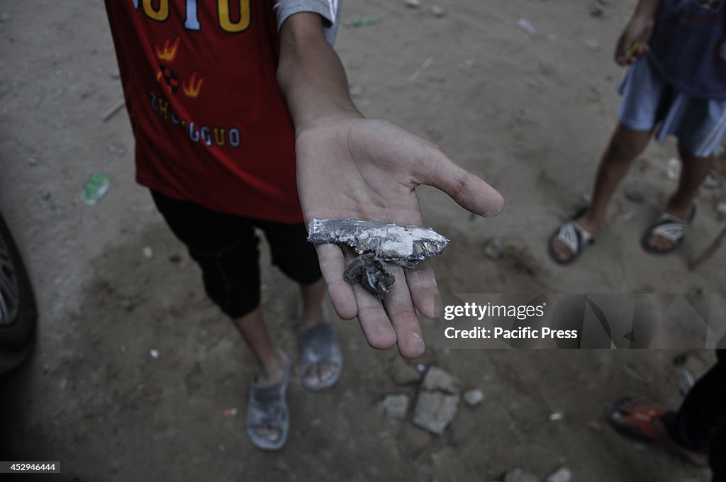 A Palestinian boy from the "Balata" family holds  a piece...