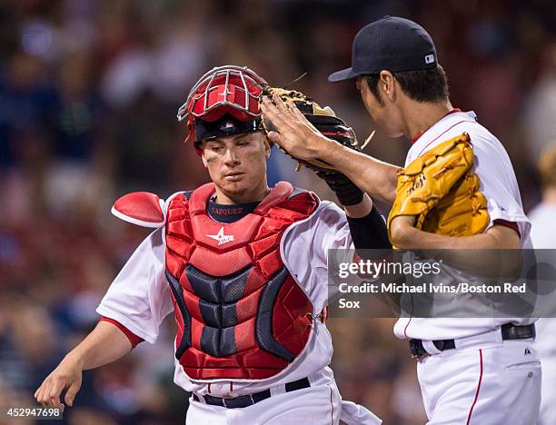 Christian Vazquez of the Boston Red Sox slaps hands with Koji Uehara after he pitched a scoreless ninth inning against the Toronto Blue Jays on July...