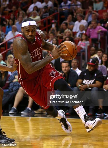 LeBron James of the Miami Heat drives during a game against the Charlotte Bobcats at American Airlines Arena on December 1, 2013 in Miami, Florida....
