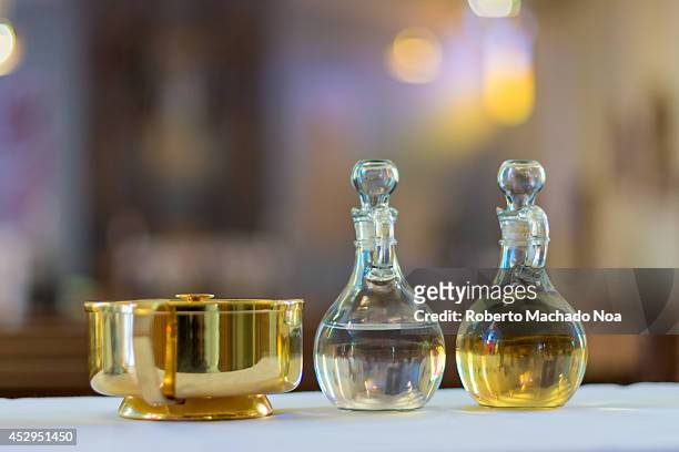 Symbols of the traditions of a Catholic Church. Holy water and oil for unction.