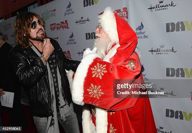 Musician Billy Ray Cyrus and a man dressed a Santa Claus arrive at the 82nd Annual Hollywood Christmas Parade on Hollywood Blvd. On December 1, 2013...