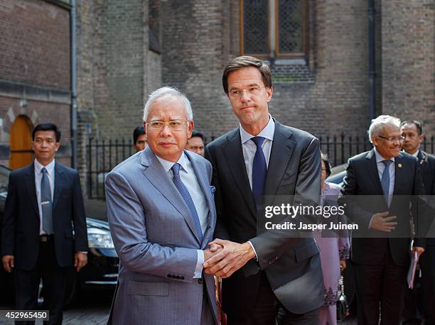 Dutch Prime minister Mark Rutte holds hands with Malaysian Prime Minister Najib Razak upon his arrival on July 31, 2014 in The Hague, Netherlands....