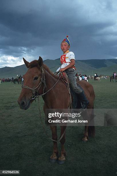 Young jockey before a race in which up to 1,000 horses can be chosen to compete. The horse races are broken down into six categories based on the age...