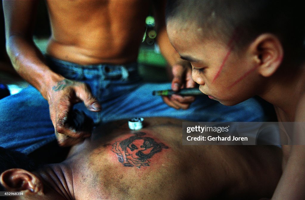 Jim-Boy watches a man have the face of Jesus tattooed onto...