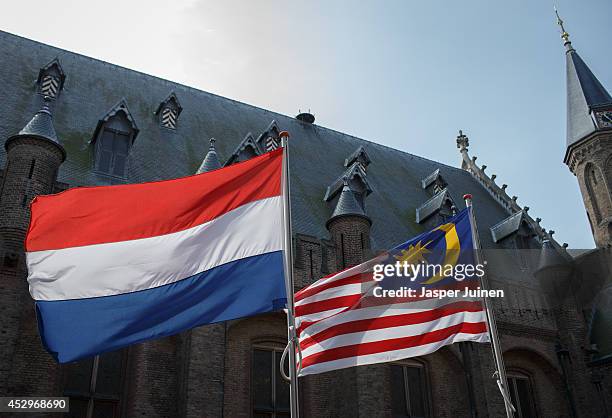 Dutch and a Malaysian flag fly prior to the arrival of Malaysian Prime Minister Najib Razak for his meeting with Dutch Prime minister Mark Rutte on...