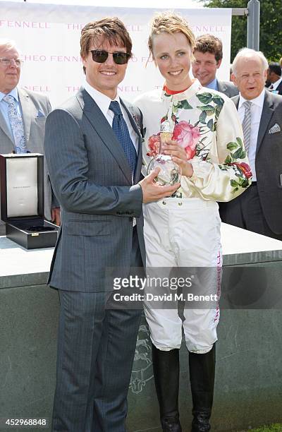 Tom Cruise presents Edie Campbell with her trophy after winning The Magnolia Cup at Glorious Goodwood Ladies Day at Goodwood on July 31, 2014 in...