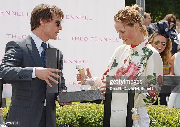 Tom Cruise presents Edie Campbell with her trophy after winning The Magnolia Cup at Glorious Goodwood Ladies Day at Goodwood on July 31, 2014 in...