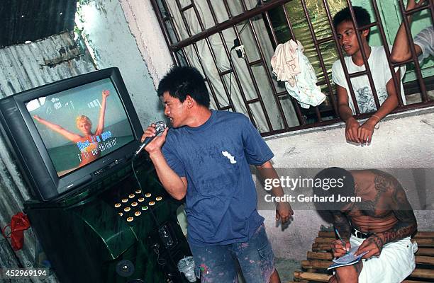 An inmate sings karaoke at the dorm of Sputnik gang, one of the four major gangs in Manila City Jail. Manila City Jail was built for 800 prisoners by...