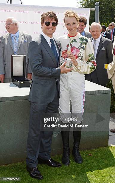 Tom Cruise presents Edie Campbell with her trophy after winning The Magnolia Cup at Glorious Goodwood Ladies Day at Goodwood on July 31, 2014 in...