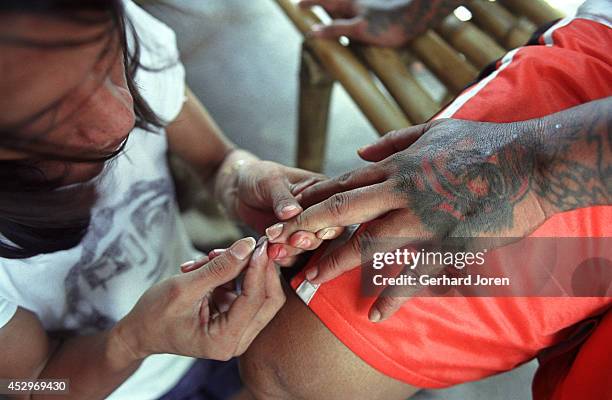 Joey, the leader for the Sputnik gang, gets a manicure from another inmate inside the jail. Joey is waiting for his murder trial. Manila City Jail...