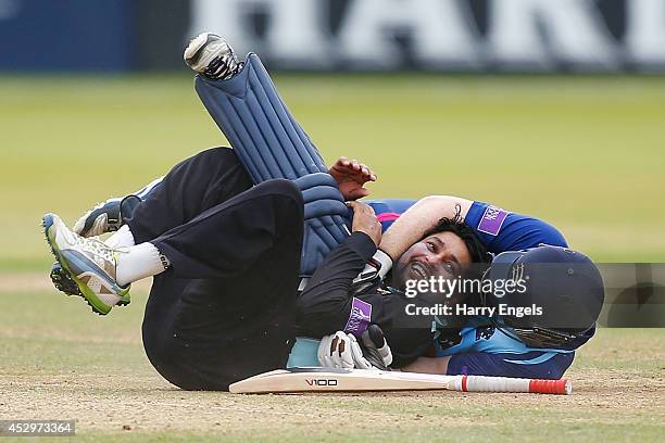 Tillakaratne Dilshan of Surrey laughs after he collided with Eoin Morgan of Middlesex during the Royal London One-Day Cup match between Middlesex...