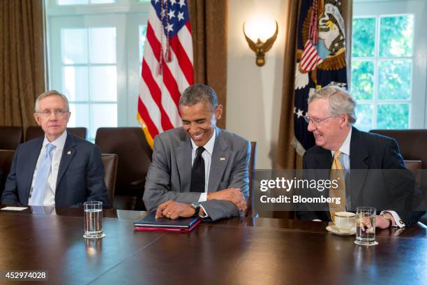 President Barack Obama, center, laughs as he talks to Senate Minority Leader Mitch McConnell, a Republican from Kentucky, right during a meeting with...