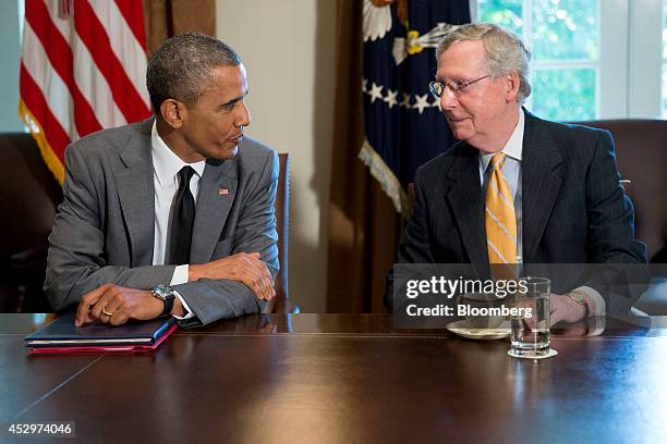 President Barack Obama, left, talks to Senate Minority Leader Mitch McConnell, a Republican from Kentucky, during a meeting with members of Congress...