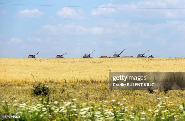 Ukrainian tanks stand guard near a field on July 31, 2014 in the village of Debaltseve, in the Donetsk region, eastern Ukraine. Dutch and Australian...