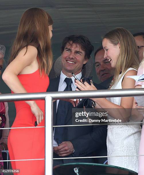 Tom Cruise chats to some female race goers at Glorious Goodwood, Ladies Day at Goodwood on July 31, 2014 in Chichester, England.
