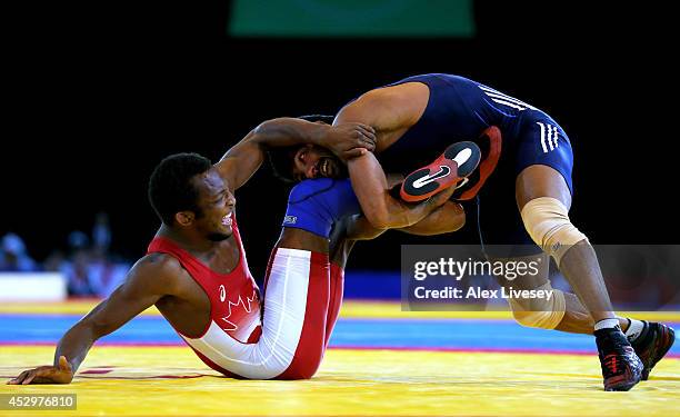 Yogeshwar Dutt of India competes against Jevon Balfour of Canada in the Men's FS 65 kg Gold medal match at Scottish Exhibition and Conference Centre...