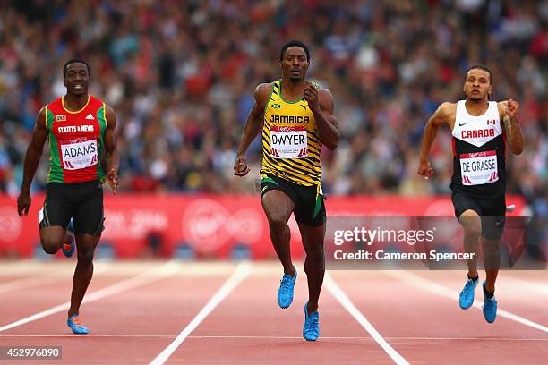 Antoine Adams of St Kitts and Nevis, Rasheed Dwyer of Jamaica and Andre de Grasse of Canada compete in the Men's 200 metres semi-final at Hampden...