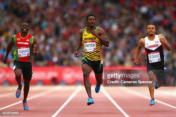 Antoine Adams of St Kitts and Nevis, Rasheed Dwyer of Jamaica and Andre de Grasse of Canada compete in the Men's 200 metres semi-final at Hampden...