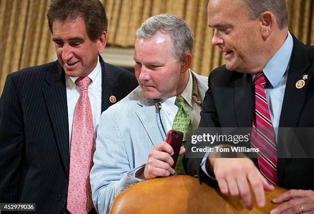 From left, Reps. Jim Renacci, R-Ohio, Tim Griffin, R-Ark., and Tom Reed, R-N.Y., confer before a House Ways and Means Committee markup in Longworth...