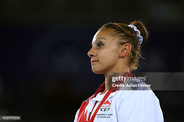 Gold medalist Rebecca Downie of England poses during the medal ceremony for the Women's Uneven Bars Final at SSE Hydro during day eight of the...